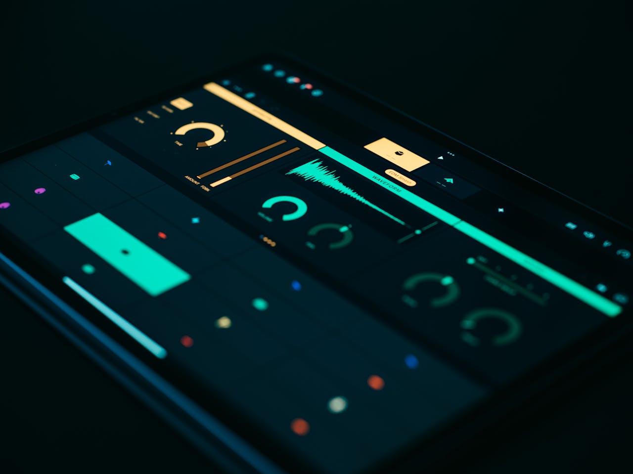 gallery-1 Close-up of a tablet screen displaying a sound visualizer with modern UI elements on a black background.